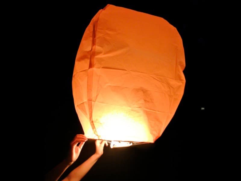 Orange sky lanterns, hot air balloon shaped for weddings,  parties and other festivities, fire resistant and biodegradable paper, mounted and strong fuel cell,  ready for use. Open, light it and let if fly!